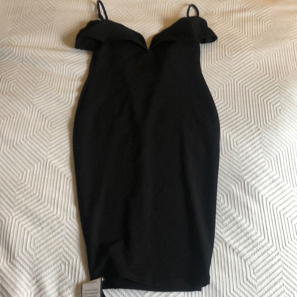 Black cocktail dress with sweetheart neckline.